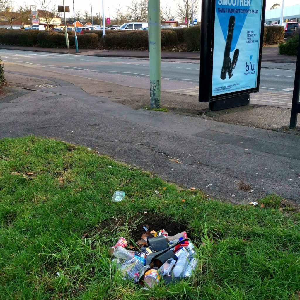 Litter in place of a missing bin.